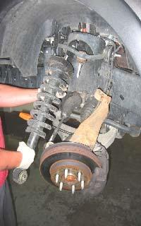 Next loosen and remove the Upper ball joint nut, Tie rod nut and Sway bar nut on the same side of the vehicle.