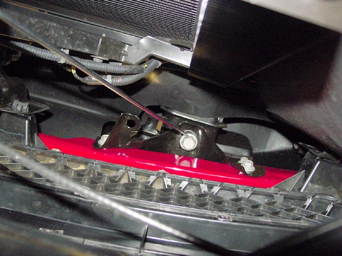 The bolts are located between the back of the grille and the radiator. Remove the bolts temporarily to install the bracket (Fig.B). 3.