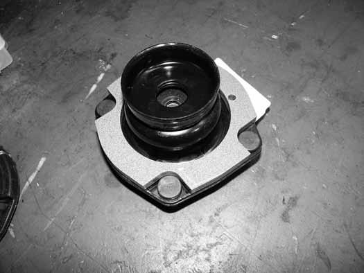 Figure 29 58. Install the factory rubber isolator on the preload spacer by aligning the hole in the spacer with the nub protruding from the isolator. 59.