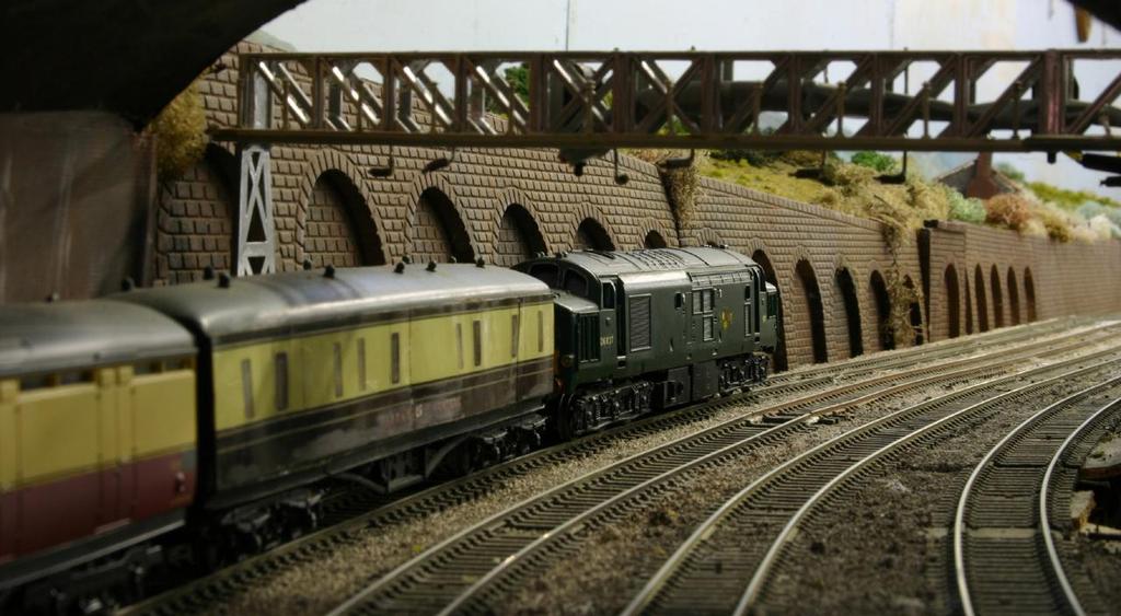 Motive power to be seen on the layout includes red Duchesses and green English Electric Type 4 diesels.
