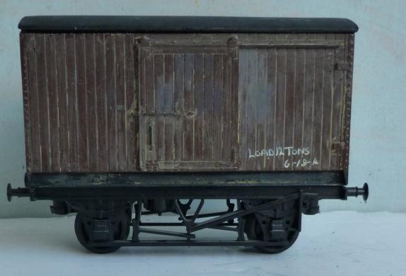1.373 0-gauge Wagons - L.M.C. L.M.C. (Leeds Model Co.) 2-axle 7-plank plastic-moulded Open Wagon, finished dark grey, with small white lettering 'N.E. 12T' and diagonal white stripe.