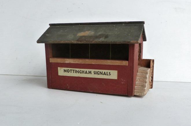 Unidentified (possibly Hugar) wooden low-profile Signal Cabin, with chimney. 'Hove' paper label affixed below glazed window, and a tinplate sign on one end.