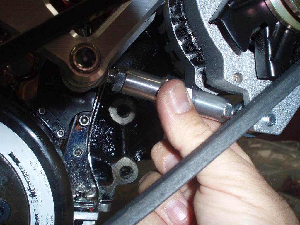 ONCE THE ADJUSTING LINK IS SECURED, THE DRIVE BELT CAN BE INSTALLED.