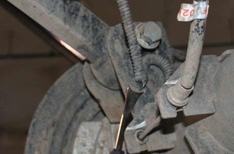 DO NOT REMOVE ARMS OR BOLTS. 1 1 Remove the shock at the axle with an 18mm.