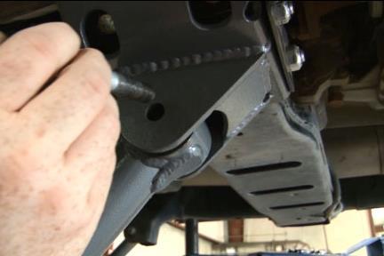 17. Install lower control arm into new bracket using stock hardware. See Photo 8. NOTE new lower control arm will be install with the pocket facing outward.