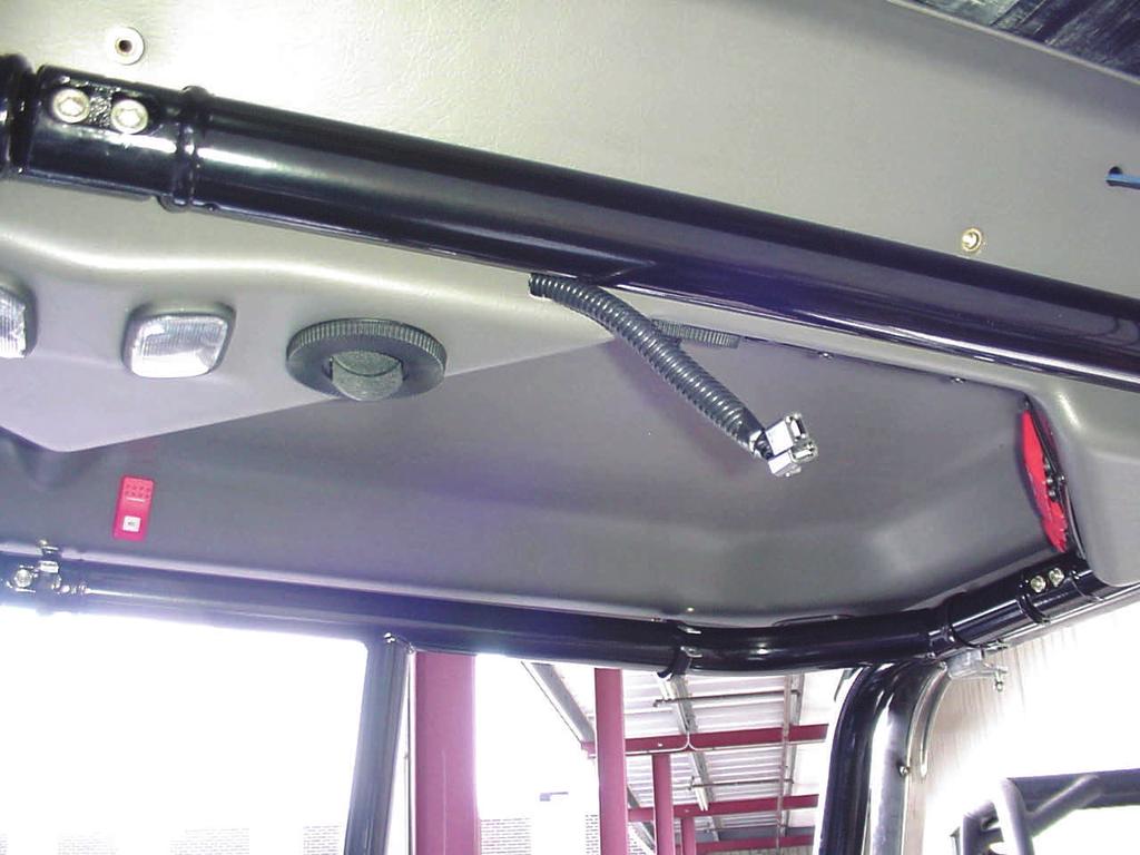 4 If not installing optional work lights, install four 1/4-20 x 3/4 long Truss head, Phillips head bolts into factory installed threaded inserts in the front of the overhead console.