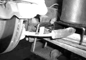 II. Mounting the Lower Bracket Passenger side mounts forward of the axle and over