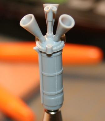 Figure 4: The escape tower braces removed from sprue and tacked down with numbered tapes in the photo. The individual pairs of rods that make up the bracing for the escape tower are different lengths.