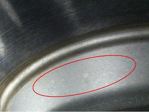 Discoloration on the brake disc due to chemical contamination from cleaner that was sprayed directly onto