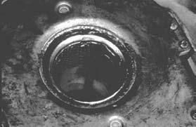 Allowing the transmission to hang unsupported in the sleeve bushing can damage the bushing. The arrow in Figure 11 shows another example of sleeve bushing damage on a heavy duty clutch.