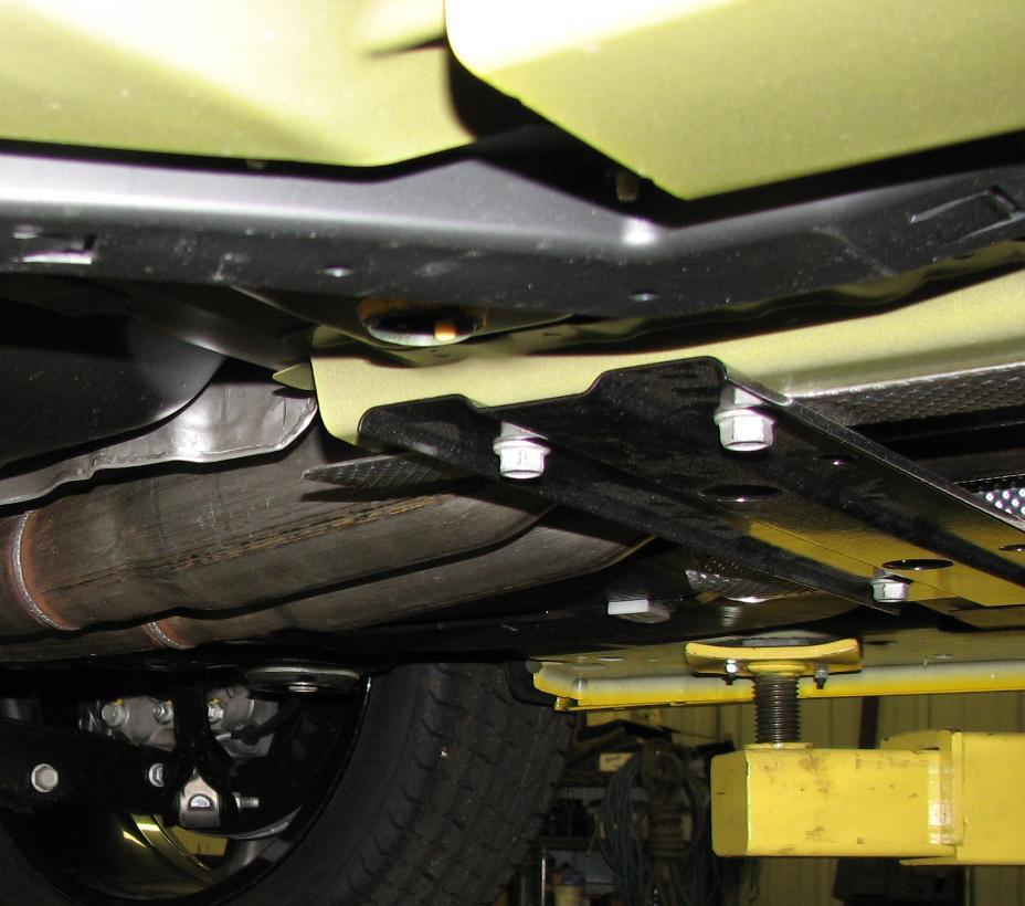 Figure 1: Removal of center support bar 3. With the aid of a helper or jack-stand, remove the entire exhaust assembly. Spraying the rubber isolators with WD-40 will make removal easier.