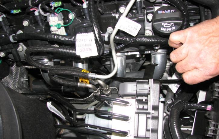 Once the manifolds are held in by a couple of bolts, lower the car again. Proceed to insert the remaining manifold bolts. 11. Tighten the exhaust manifold bolts beginning with the center two bolts.