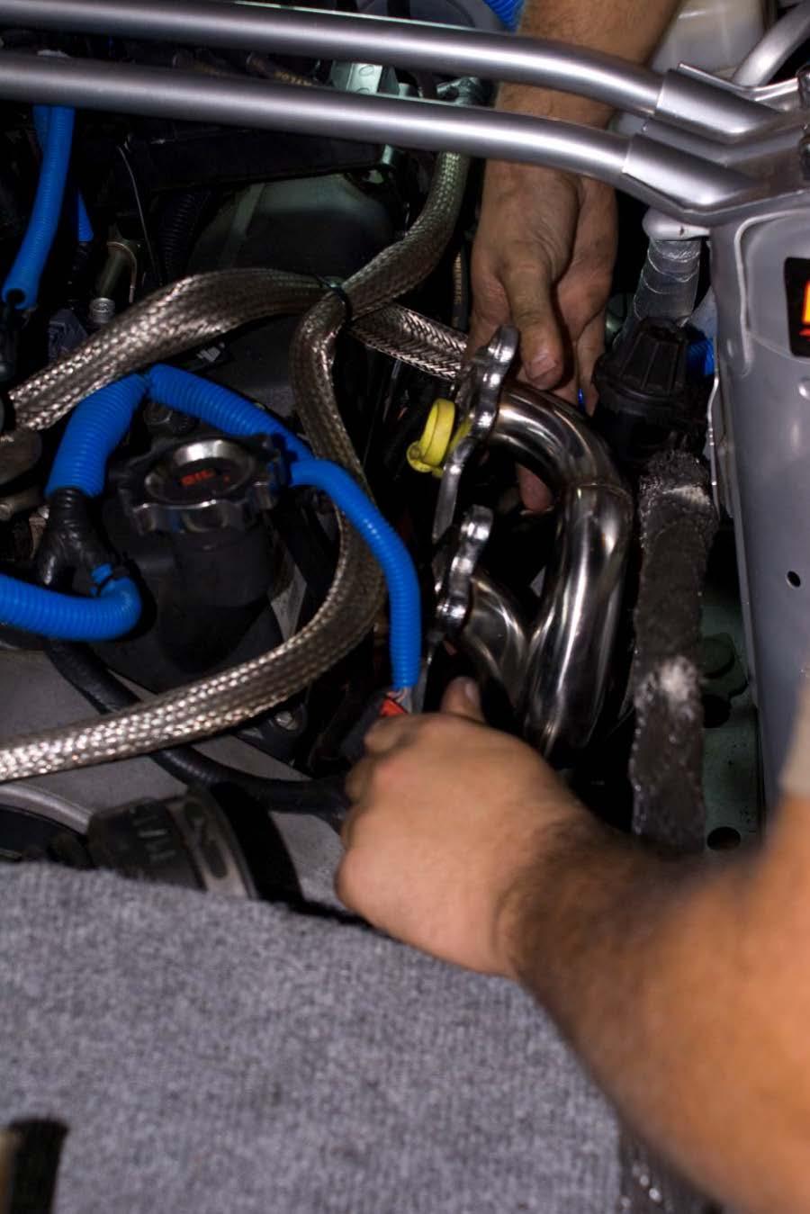 Installation of new Driver Side Header: -Carefully place one of the supplied exhaust gaskets on the engine block exhaust manifold studs.