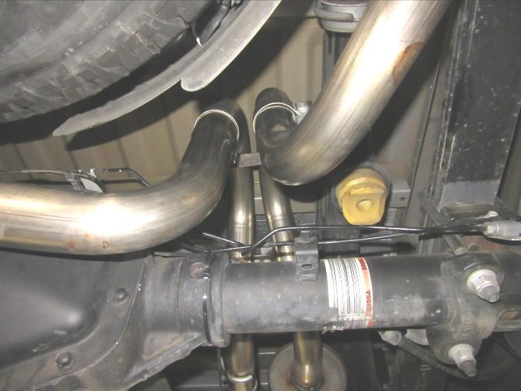 Install hanger bracket assembly to the left-side and right-side lower spring mount bolts (See Fig. 13) 6.