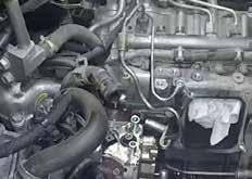 Disconnect the pressure fitting in the valley and loosen clamp at fuel filter housing