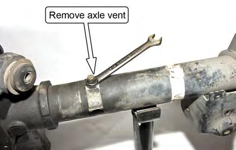 Remove the axle vent and the sheet metal bracket it retains on the axle using a 9/16 wrench. 10.