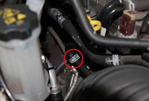 5. Locate the spring clamp retaining the PCV hose. See Figure 4. Using appropriate pliers loosen the clamp and slide it up over the metal tube and out of the way.