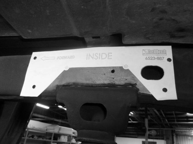 4c) Secure the template for the side of the vehicle you are working on labeled INSIDE on the inside of the frame rail with the notch portion just above the bump stop bracket.