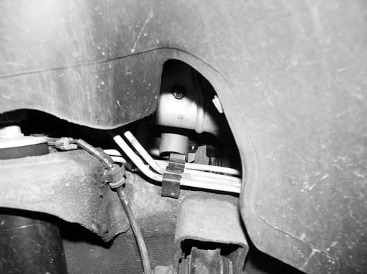 Separate the parking brake cable at the coupler just below the driver s side door Figure 12.