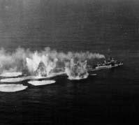 66 Climate Naval Warfare bridge and yellow flames sprang out, obliterating the shapes of the German machines swooping over the convoy. The sea leapt up in columns where their bombs were dropped.