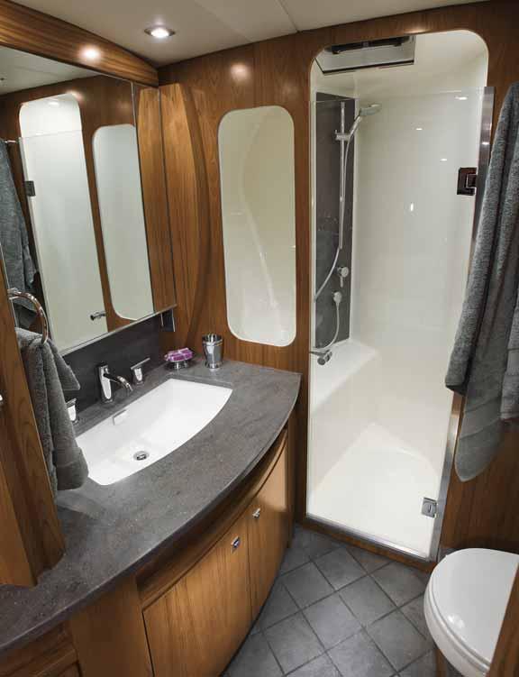 flooring, Corian countertop vanity, porcelain sink, mirror, separate shower with