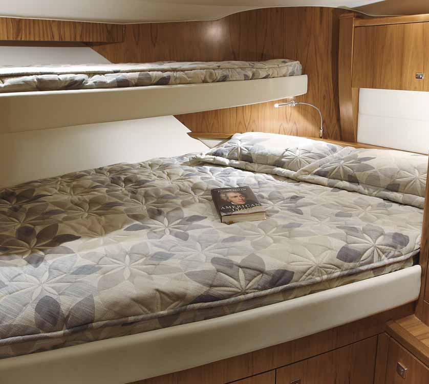 The FORWARD GUEST STATEROOM features a full frame entry door, 2 bunks (double lower/single upper), both with innerspring mattresses, quilts and pillow