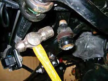 Disconnect the steering drag link from the pitman arm to ensure it doesn t bind when installing the new coil springs. Remove the tie rod end nut and dislodge the tie rod end from the pitman arm.