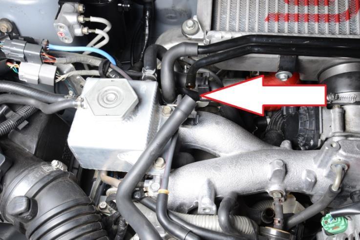 Using the ½ PCV hose included in the kit, connect one end of the hose to the crankcase ventilation pipe and route it over to the top port hose end.