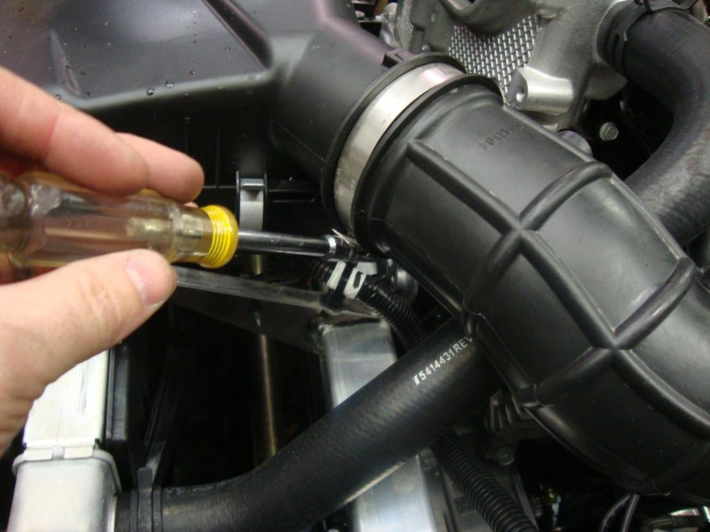 Open your hood and on the drivers side of the engine bay you will see a rubber hose like the picture to the right. That hose is held in place with 2 hose clamps, one hose clamp at each end.