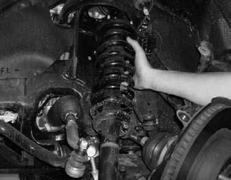 Carefully raise up on the hydraulic floor jack until it comes into contact with the stock lower control arm. Repeat procedure on the passenger side. 11.