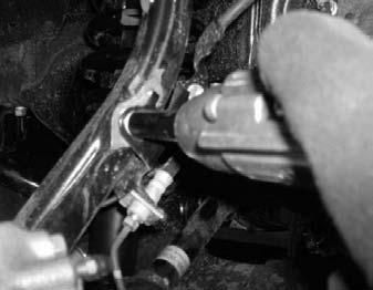 Working on driver side, install the stock cotter back into the stock upper the driver side, secure the stock ABS bracket to the stock control arm ball joint.