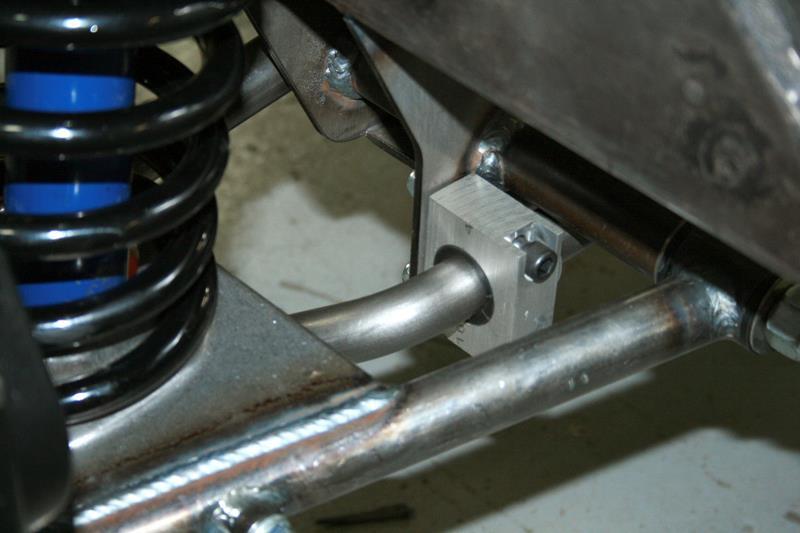 The anti-sway bar mounts to the rear of the cross member below the lower control arm pins. Use the supplied hardware to install the aluminum blocks onto the cross member.