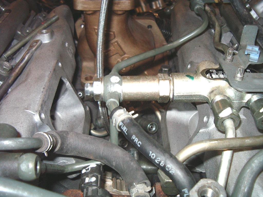 Attach hose to fuel filter with existing fuel line clamp.