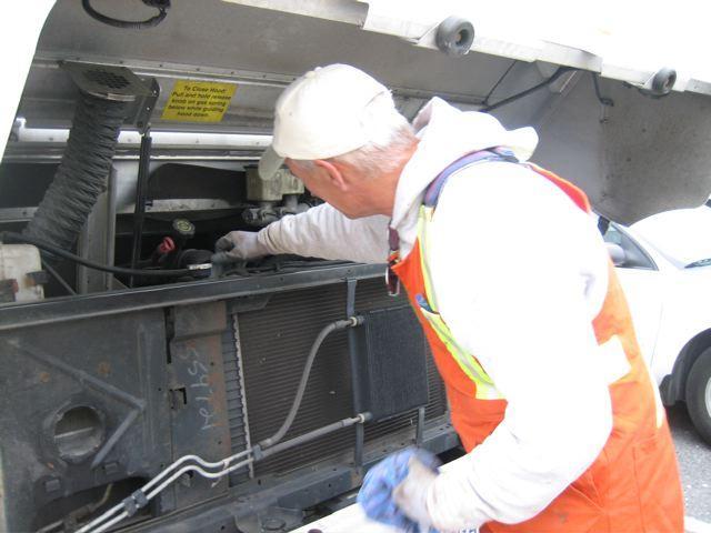 Figure 11: Ops III worker performing pre-trip vehicle inspection.