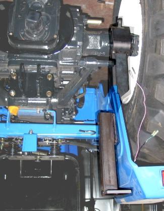 Take the left rear axle support bracket and position it over the axle where the 2-post ROPS was mounted. Re-use the ROPS hardware for the bottom two bolts.