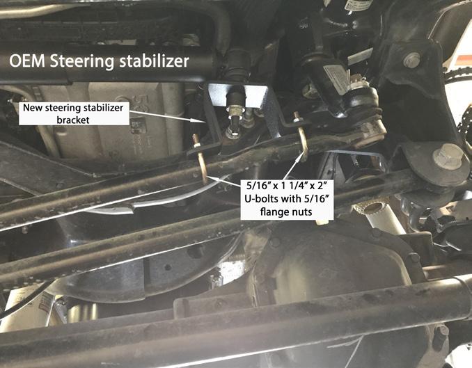 Install the new steering stabilizer bracket directly over the OE mounting hole on the steering drag link using the new 5/16 ubolts and flange nuts 28. Locate the new front shocks.