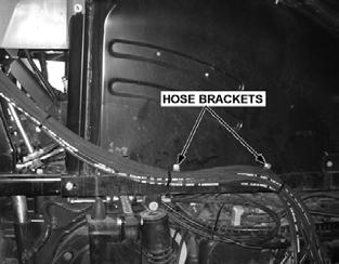 ASSEMBLY LIFT VALVE HOSE AND CABLE ROUTING Attach two clamps to the right rear wheel well for proper hose/cable routing. Drill one hole for each clamp.
