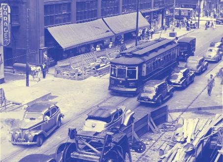 In 1941, construction of the Dearborn Street subway was underway in this view south of Washington Street. The 5000-series Brill streetcar operated on the Wallace/Racine line.