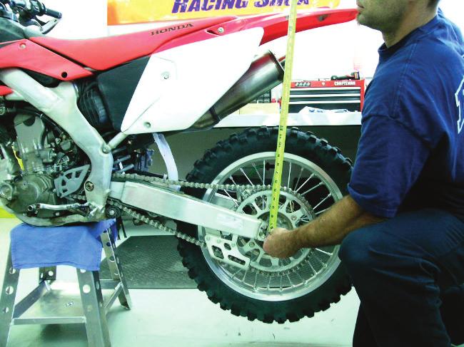 4. Have an assistant measure and record the distance from the rear axle to the same fixed point used in step 2. This is RIDER SAG measurement #2 (S2). See the picture S2 on the next page.