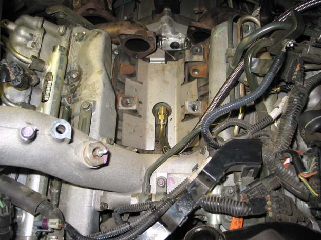 OIL SUPPLY Install the four studs into the turbo pedestal by screwing together two nuts onto the studs and