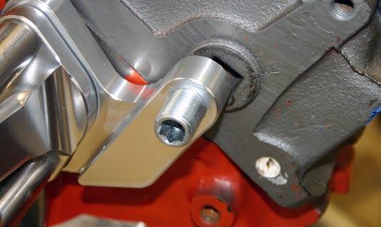 700) behind the alternator mounting ear and adjust the Adjustment Spacer (S450) so its tight to