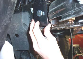 Now, place a ½" x 4½" bolt over a ¼" x 2" x 3" backing plate and into the hole now visible