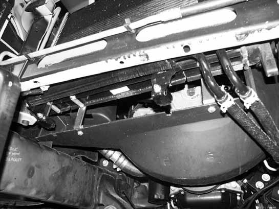 52. Place a ½ OD x 1-9/16" long crush sleeve in between the front and rear radiator flanges, lined up with the appropriate existing hole and fasten the fan shroud bracket to the radiator, through the