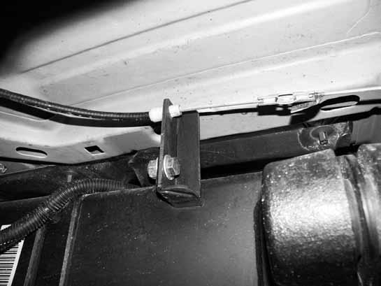 Figure 13 34. Run the parking brake cable through the new relocation bracket and reattach it to the coupler. Adjust the parking brake cable to the appropriate slack. 35.