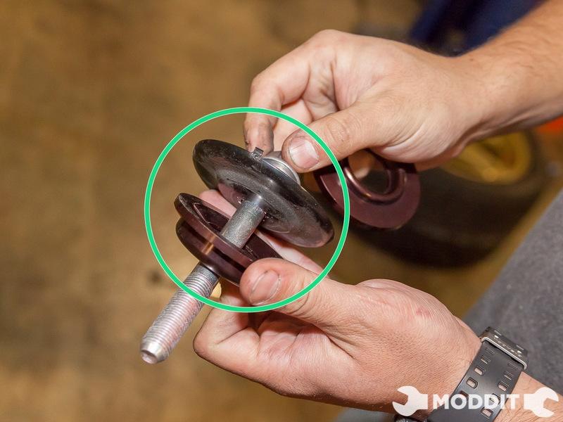 Using your Socket, loosen the rear main bushing bolt from the body. This area is located right behind the exhaust muffler.