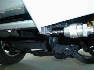 Align bar with vehicle grille and flares, and tighten bolts using socket, extension and a universal joint through fog light