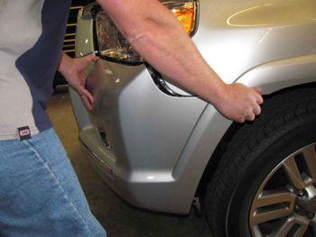 PREPARATION TO VEHICLE. 18. Carefully, and ideally with the aid of a friend, unclip each outer of the bumper at the guard as shown and remove bumper. 19.