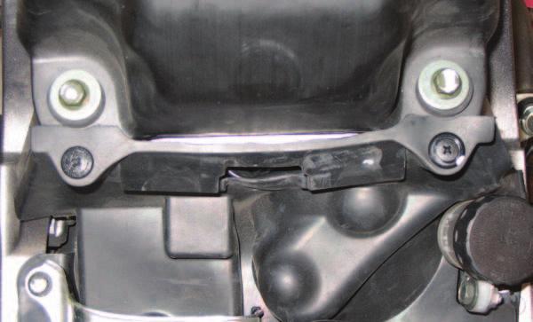 Route the harness behind the air box mounting tab as shown in Figure B.