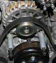 Install this bolt assembly into the passenger s side alternator mount. 44 44. On the driver s side, remove the Whipple idler pulley and bracket between the alternator and timing chain cover.