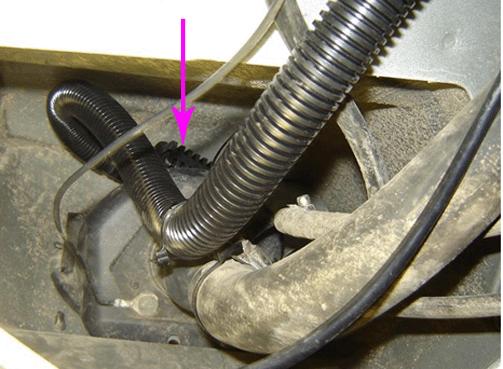 20. Raise the fuel tank filler pipe housing, and the fuel tank fill pipe back to its original position. Ensure that the CVS valve pre-filter screen openings are pointing downward as shown. 21.